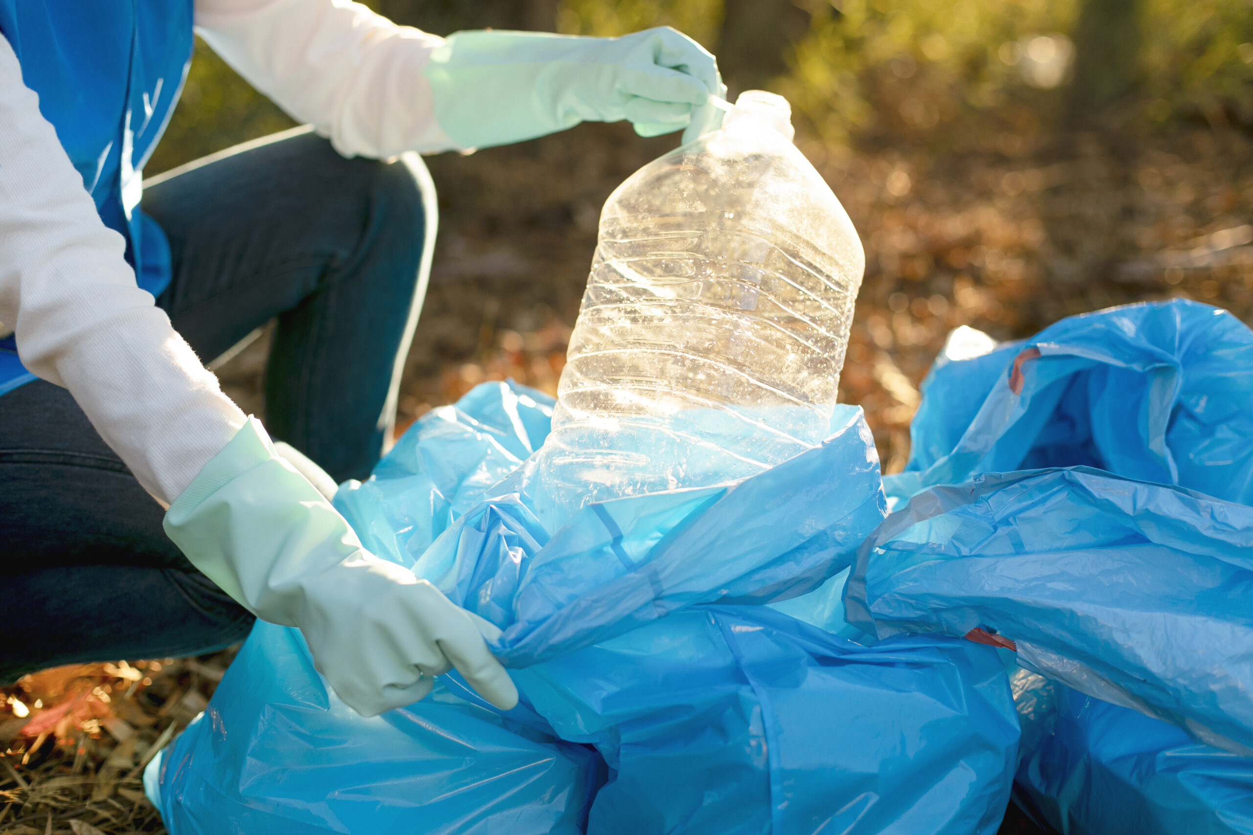 close-up-hands-collecting-plastic